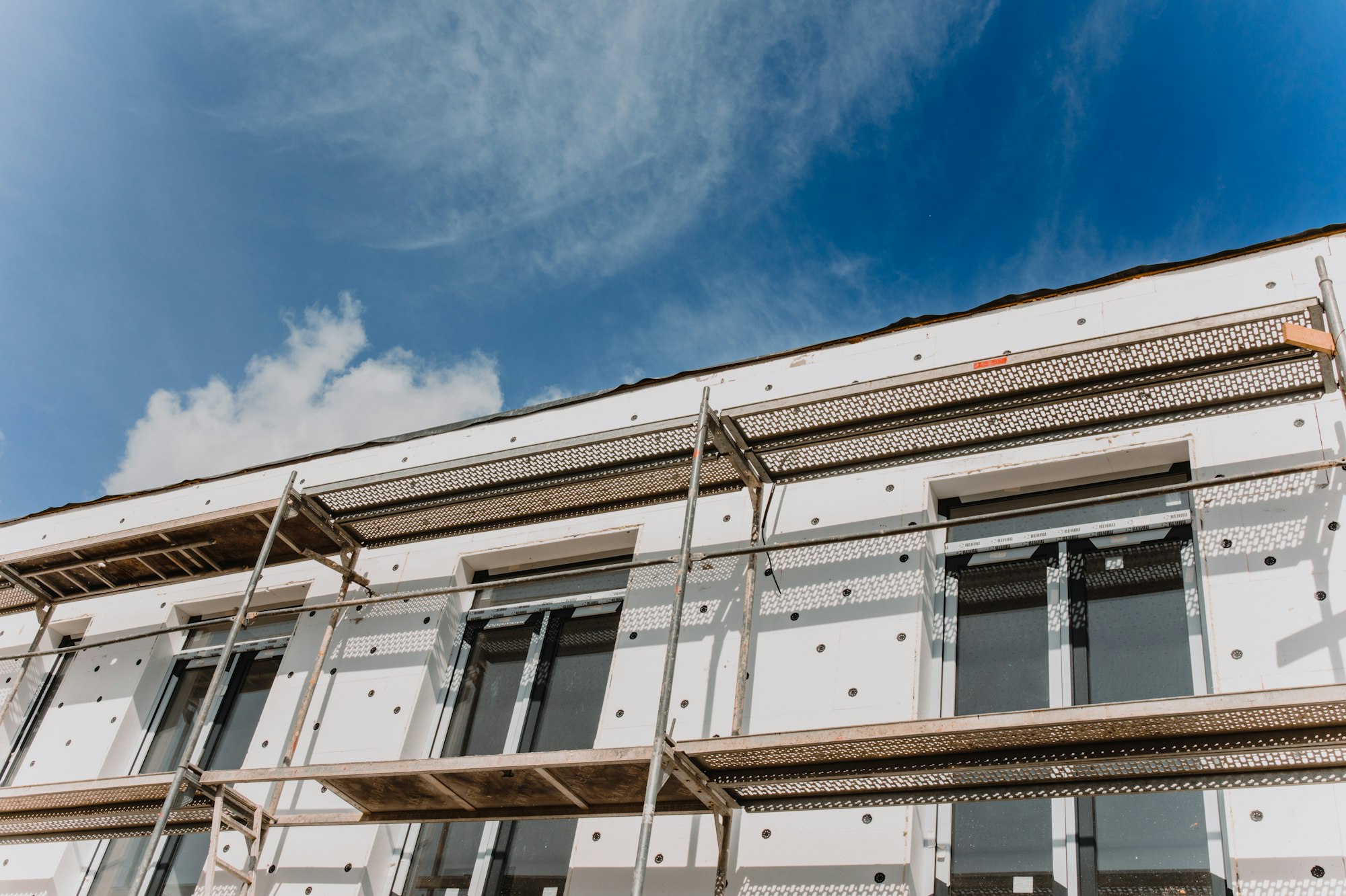 scaffolding on house facade,modern building under construction -